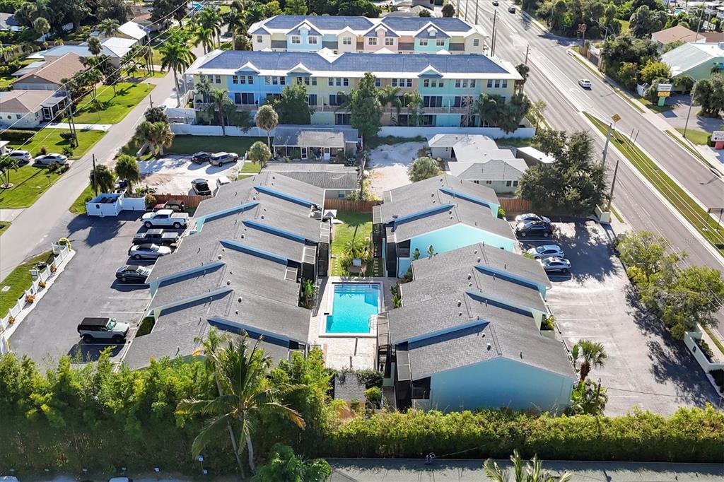 1762 Stickney Point Road, Unit 204 Sarasota, FL 34231 - Photo 36 of 38 an aerial view of multiple houses with yard
