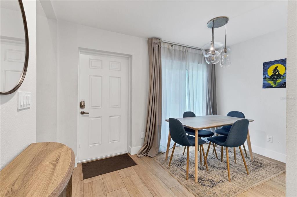 1762 Stickney Point Road, Unit 204 Sarasota, FL 34231 - Photo 4 of 38 a view of a dining room with furniture and wooden floor