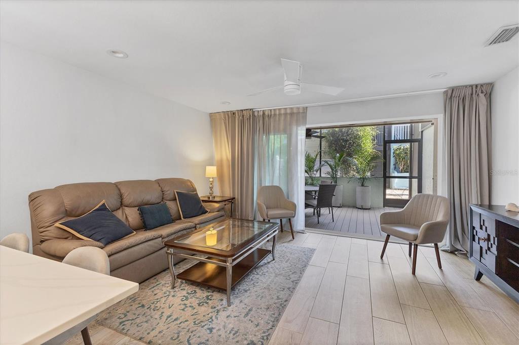1762 Stickney Point Road, Unit 204 Sarasota, FL 34231 - Photo 5 of 38 a living room with furniture and a window