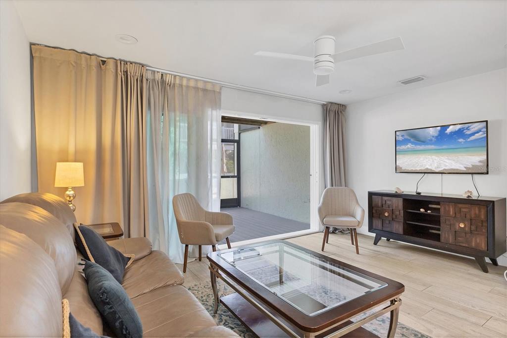 1762 Stickney Point Road, Unit 204 Sarasota, FL 34231 - Photo 7 of 38 a living room with furniture and a flat screen tv