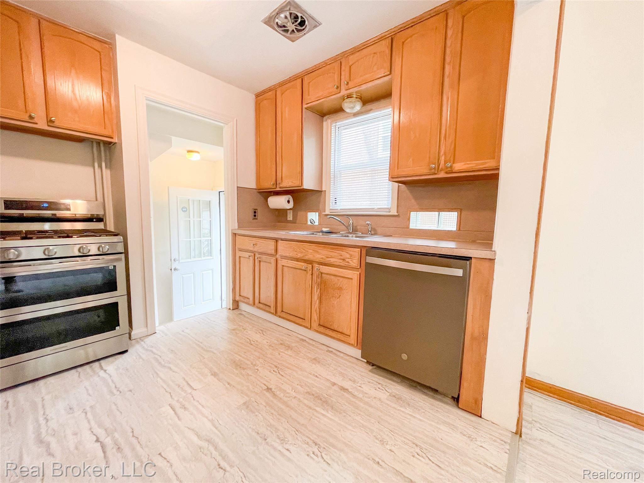 603 Vernier Road Grosse Pointe, MI 48236 - Photo 4 of 33 Kitchen with stainless steel appliances, light wood finish cabinets, light countertops, and light wood-style floors