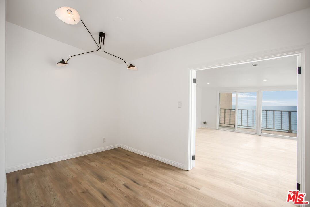 20644 Pacific Coast Highway Malibu, CA 90265 - Photo 11 of 32 a view of a room with wooden floor and windows