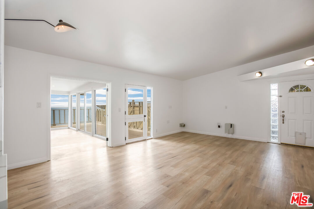20644 Pacific Coast Highway Malibu, CA 90265 - Photo 13 of 32 a view of an empty room with wooden floor and a window
