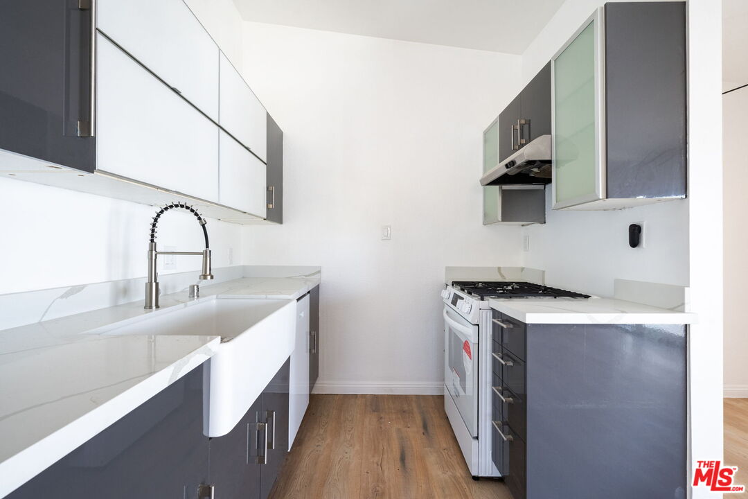 20644 Pacific Coast Highway Malibu, CA 90265 - Photo 17 of 32 a kitchen with a sink and a stove top oven