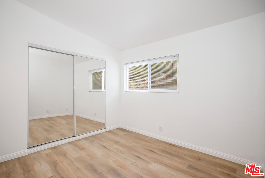 20644 Pacific Coast Highway Malibu, CA 90265 - Photo 21 of 32 a view of empty room with wooden floor and fan