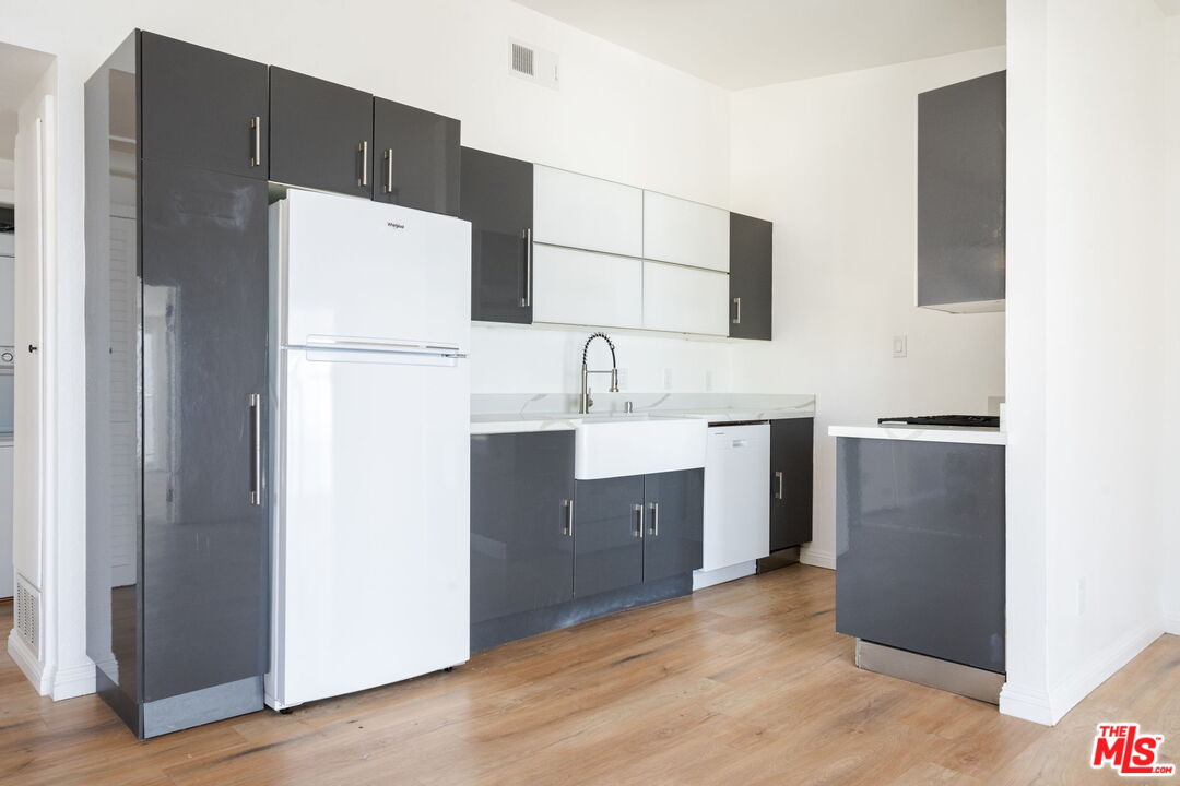 20644 Pacific Coast Highway Malibu, CA 90265 - Photo 3 of 32 a kitchen with a refrigerator sink stove and cabinets