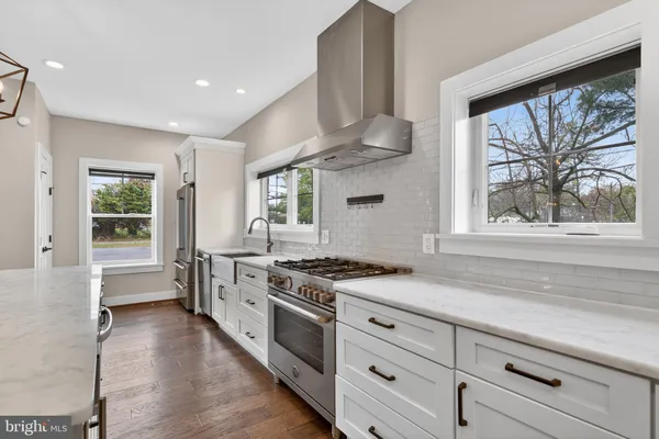 a kitchen with stainless steel appliances granite countertop a stove a sink and a refrigerator