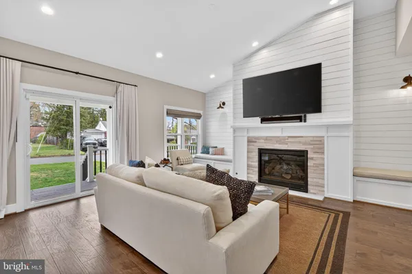 a living room with fireplace furniture and a flat screen tv
