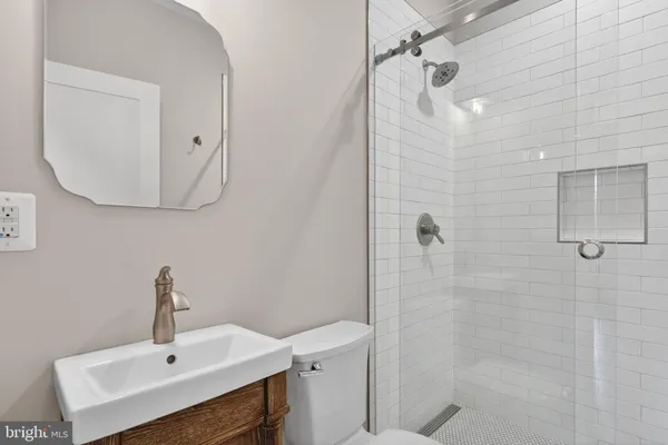 a bathroom with a sink a mirror and shower