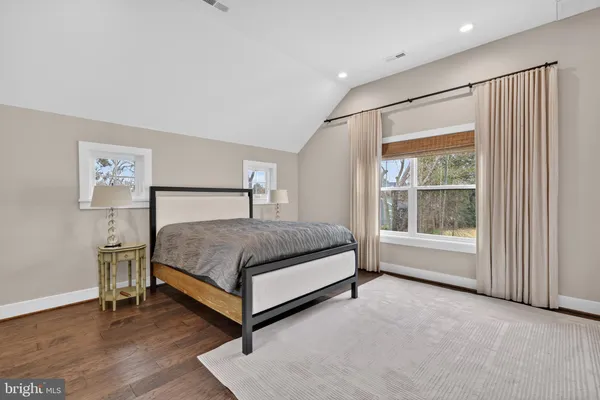 a bedroom with a bed lamp and window