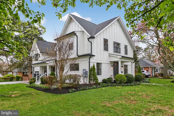 a front view of a house with a garden and yard