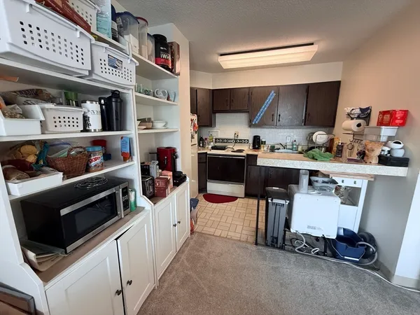 a kitchen with stainless steel appliances kitchen island granite countertop a stove and a sink