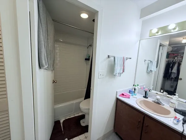 a bathroom with a sink vanity and a mirror