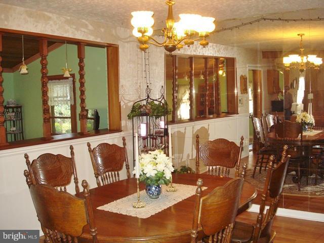 3714 Leverton Street Silver Spring, MD 20906 - Photo 15 of 24 a dining room with furniture a chandelier and wooden floor