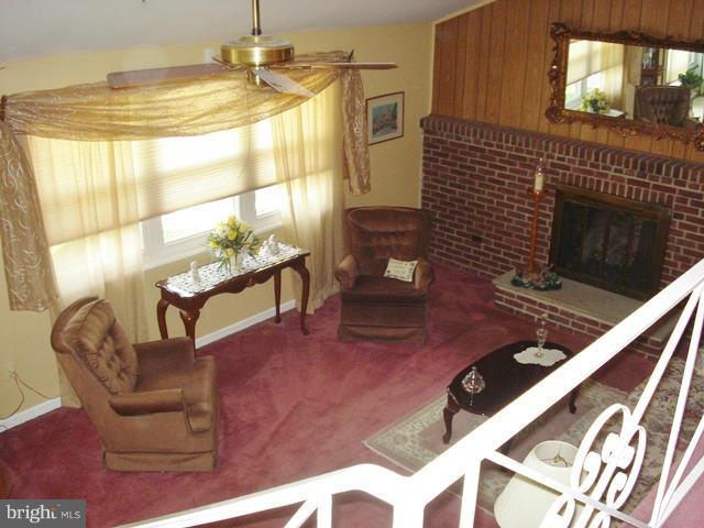 3714 Leverton Street Silver Spring, MD 20906 - Photo 5 of 24 a living room with furniture and a fireplace