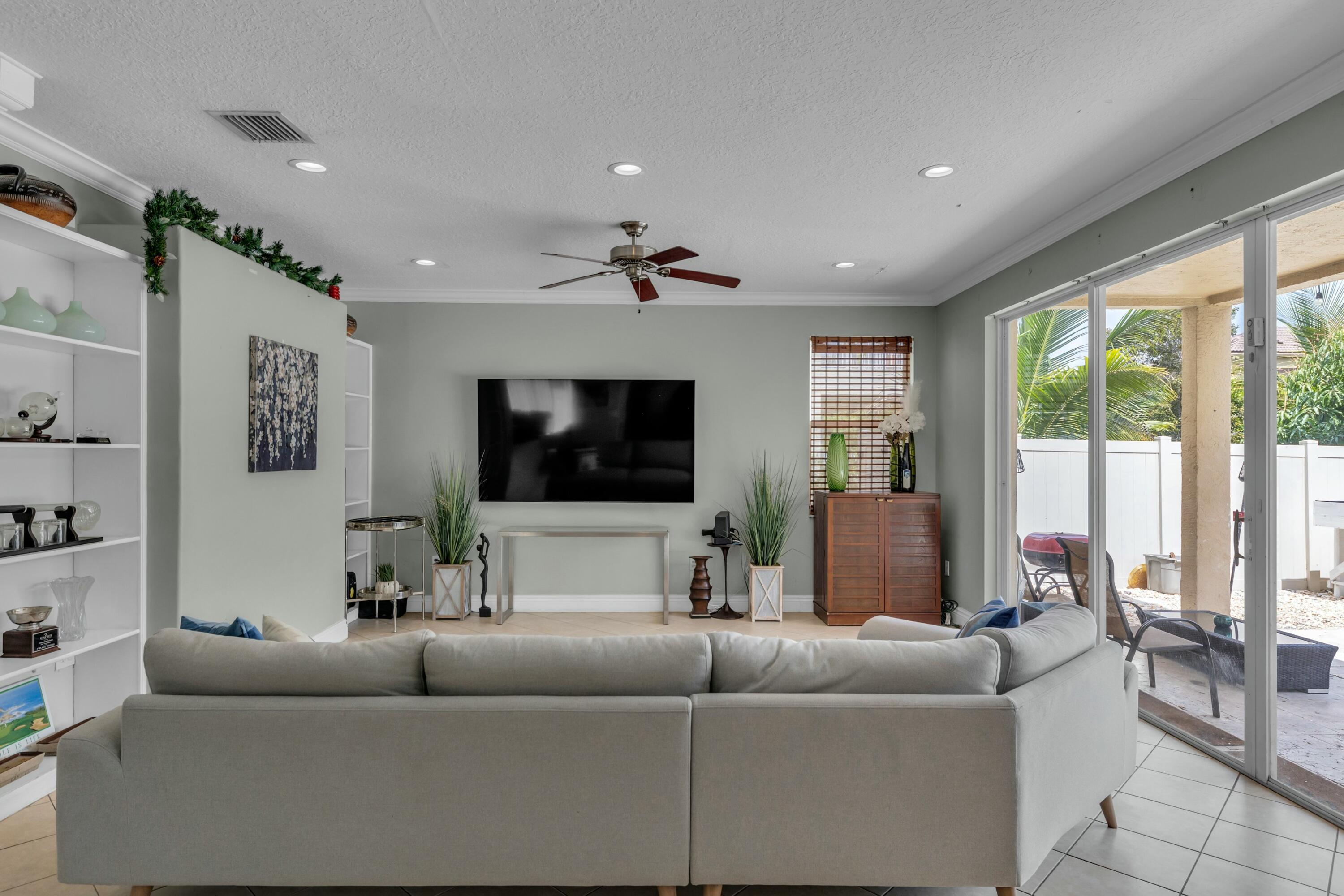 9895 Shepard Place Wellington, FL 33414 - Photo 22 of 60 a living room with furniture and a flat screen tv