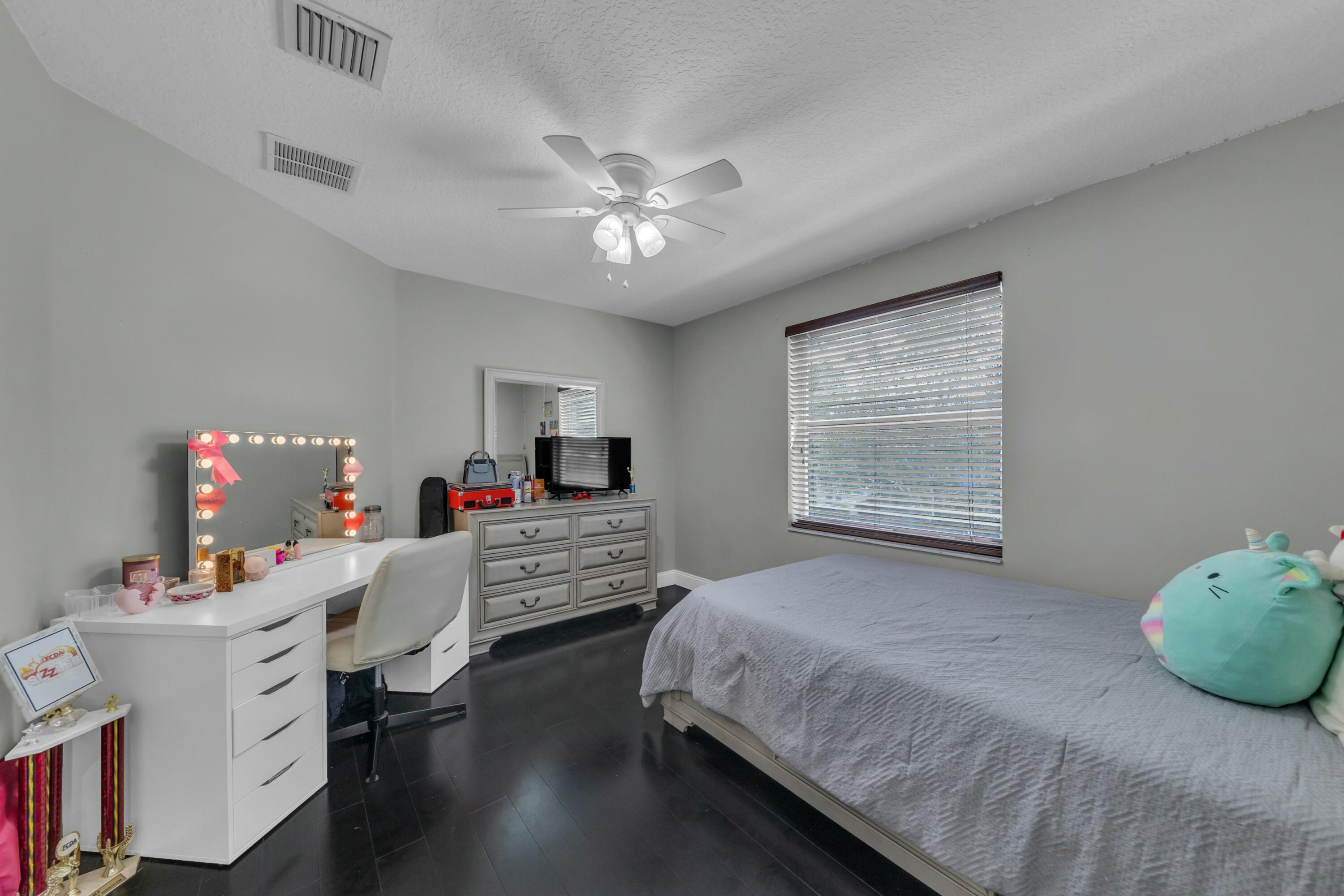 9895 Shepard Place Wellington, FL 33414 - Photo 29 of 60 a bedroom with a bed and a window