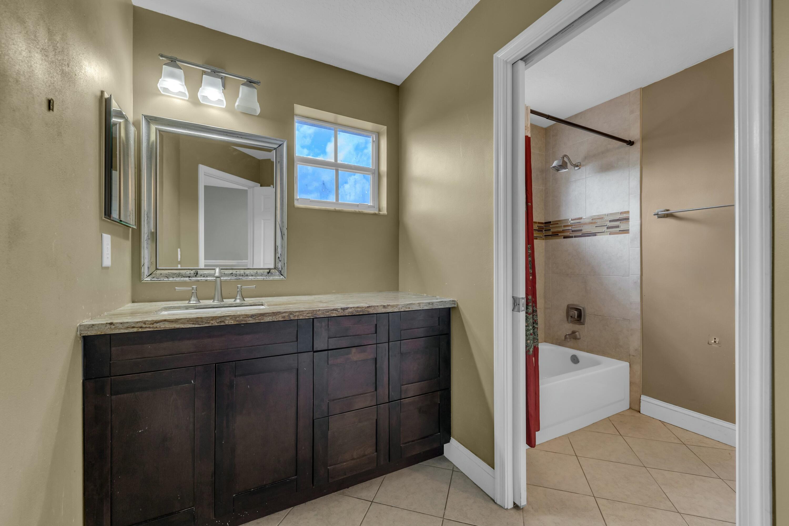 9895 Shepard Place Wellington, FL 33414 - Photo 31 of 60 a bathroom with a bathtub and a sink