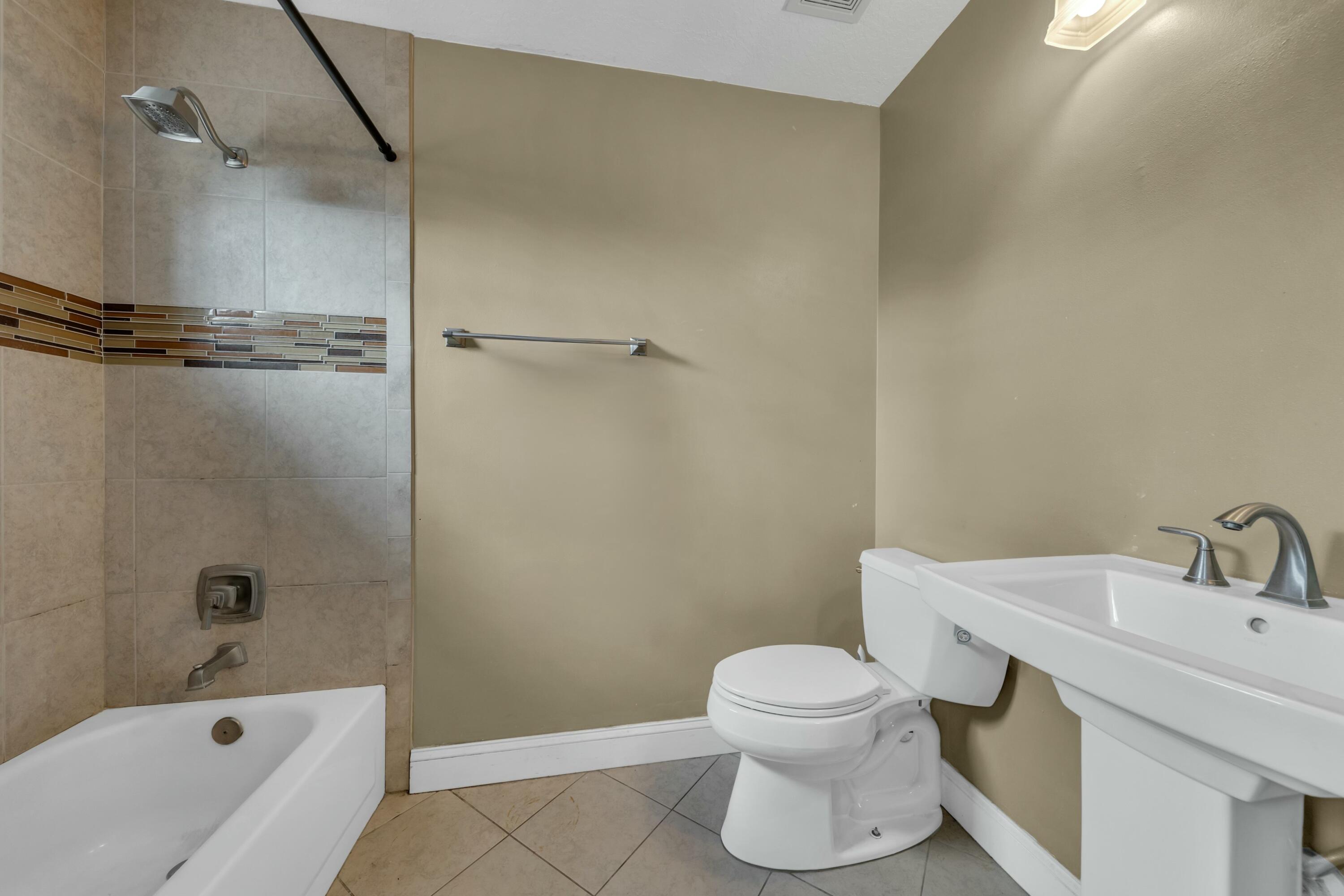 9895 Shepard Place Wellington, FL 33414 - Photo 32 of 60 a bathroom with a sink toilet and shower