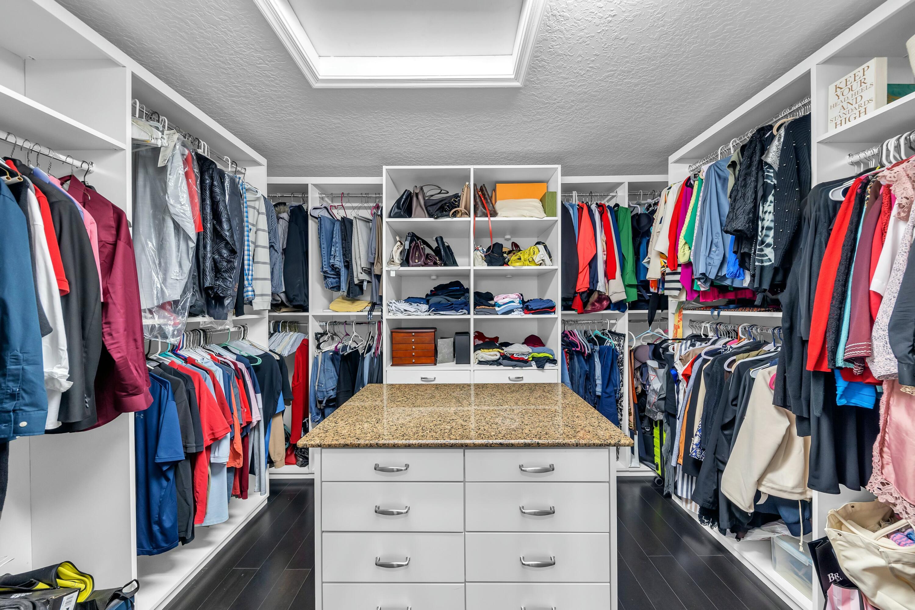 9895 Shepard Place Wellington, FL 33414 - Photo 41 of 60 a view of walk in closet with clothes