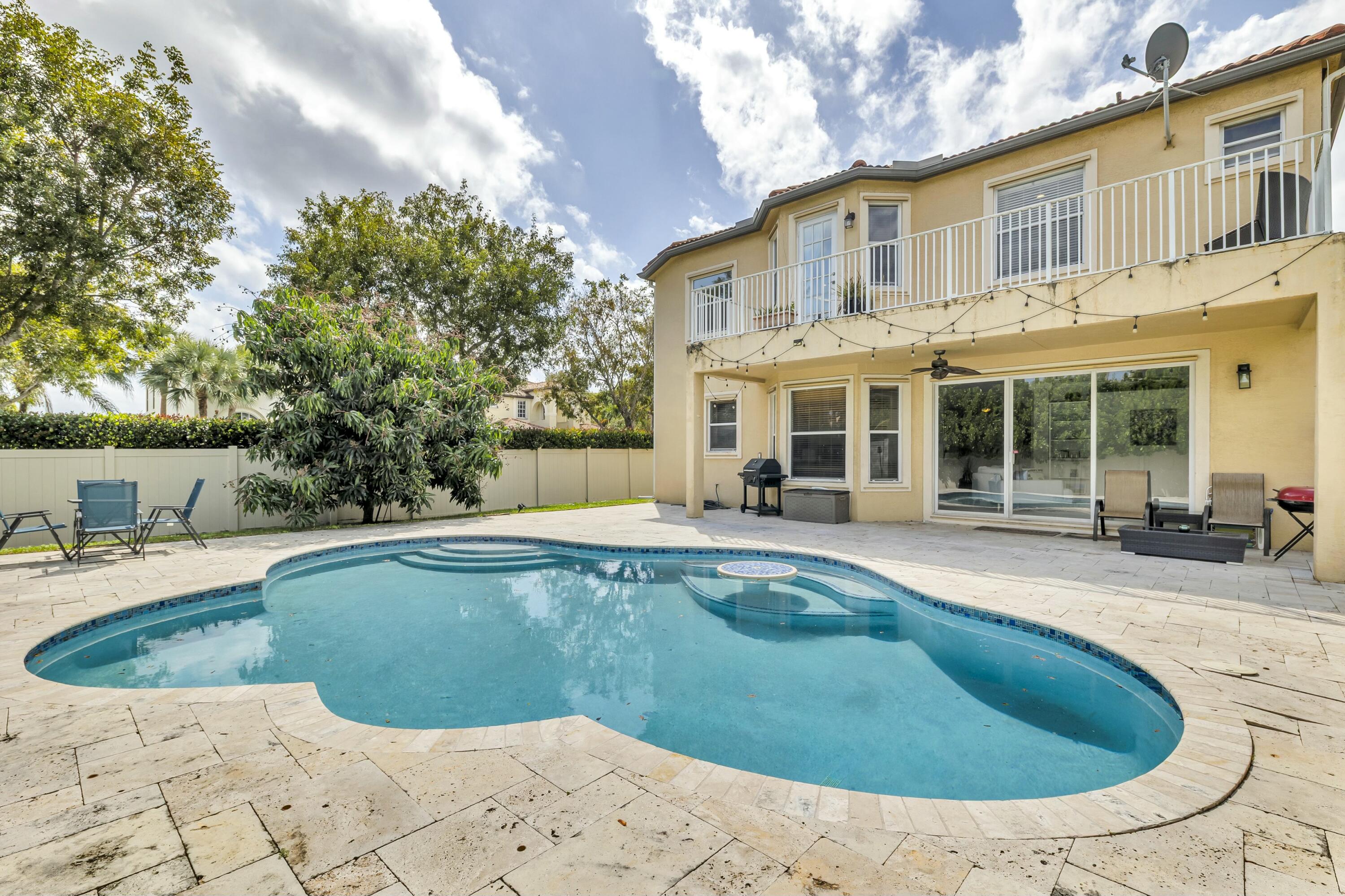 9895 Shepard Place Wellington, FL 33414 - Photo 46 of 60 a view of a house with swimming pool and porch