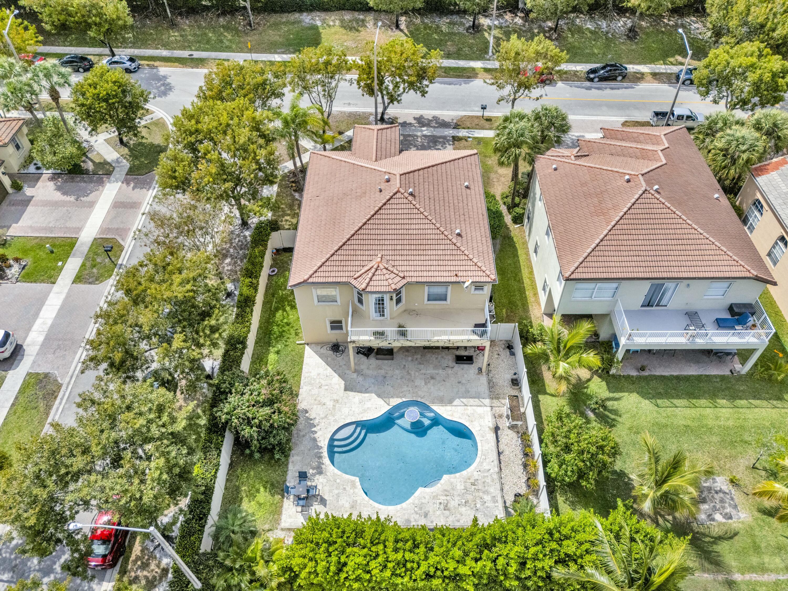 9895 Shepard Place Wellington, FL 33414 - Photo 53 of 60 an aerial view of residential houses with outdoor space and lake view
