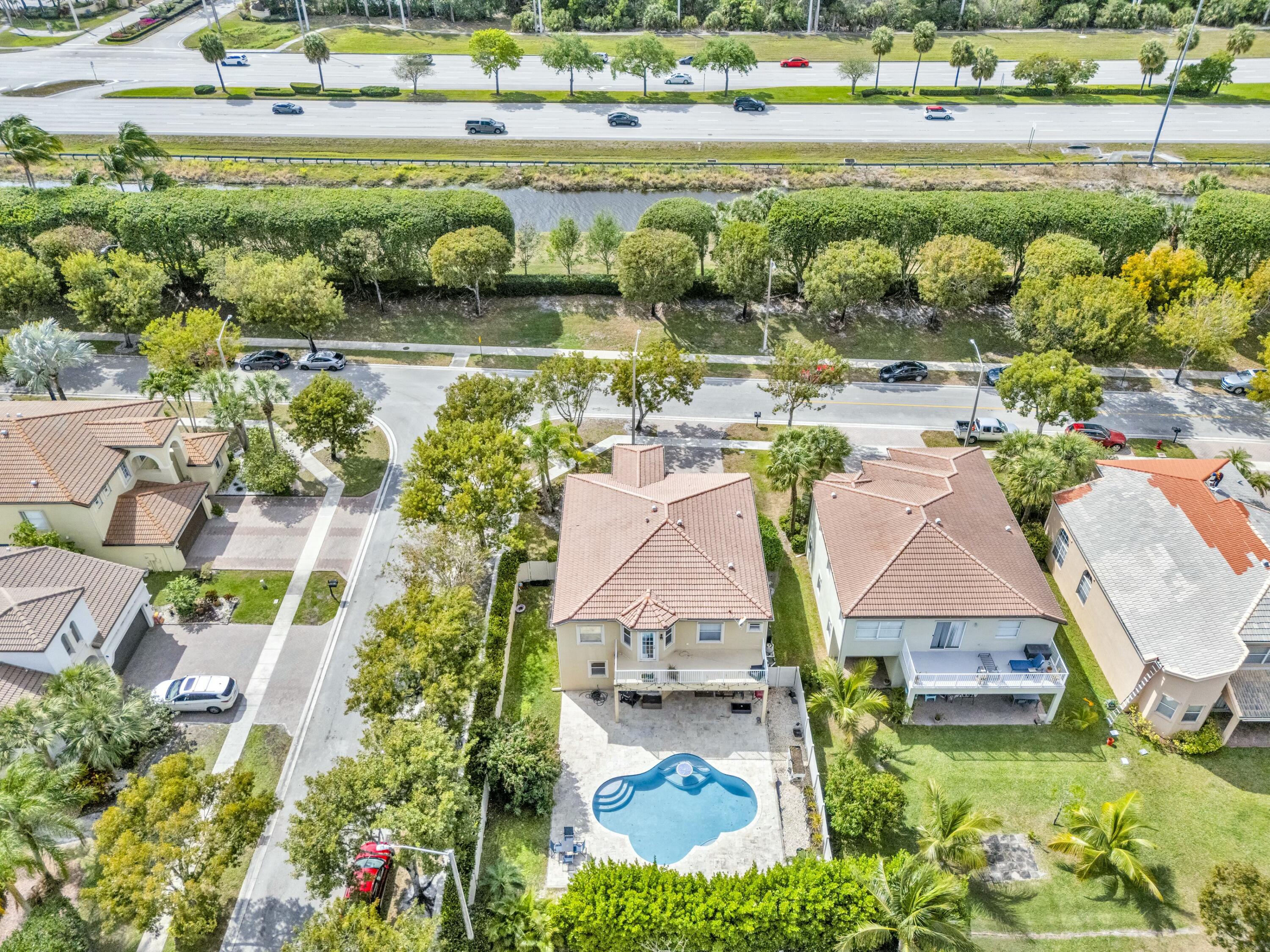 9895 Shepard Place Wellington, FL 33414 - Photo 54 of 60 an aerial view of a house with a garden and lake view