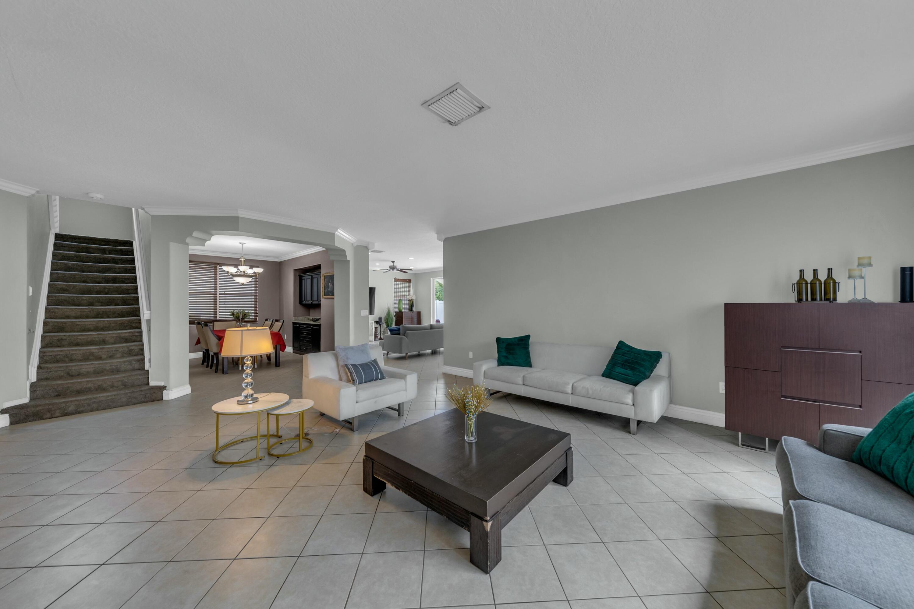 9895 Shepard Place Wellington, FL 33414 - Photo 8 of 60 a living room with furniture and a couch