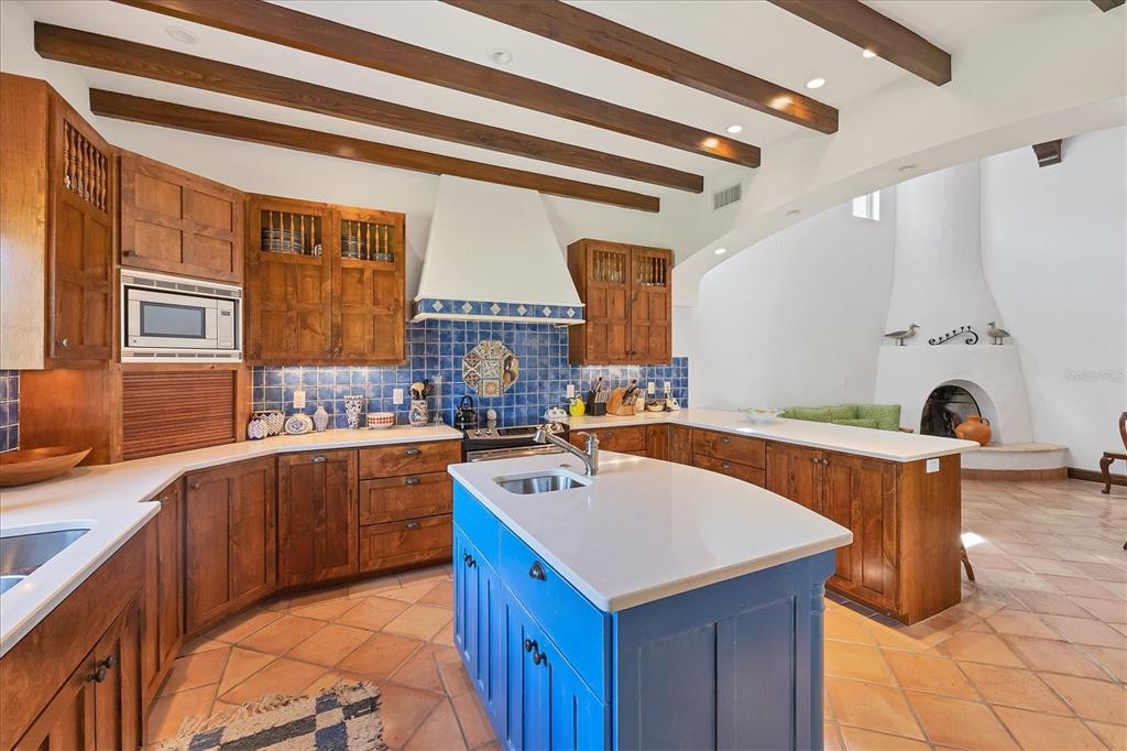 1021 10th Street West Boca Grande, FL 33921 - Photo 12 of 34 a kitchen with a sink a stove and chairs