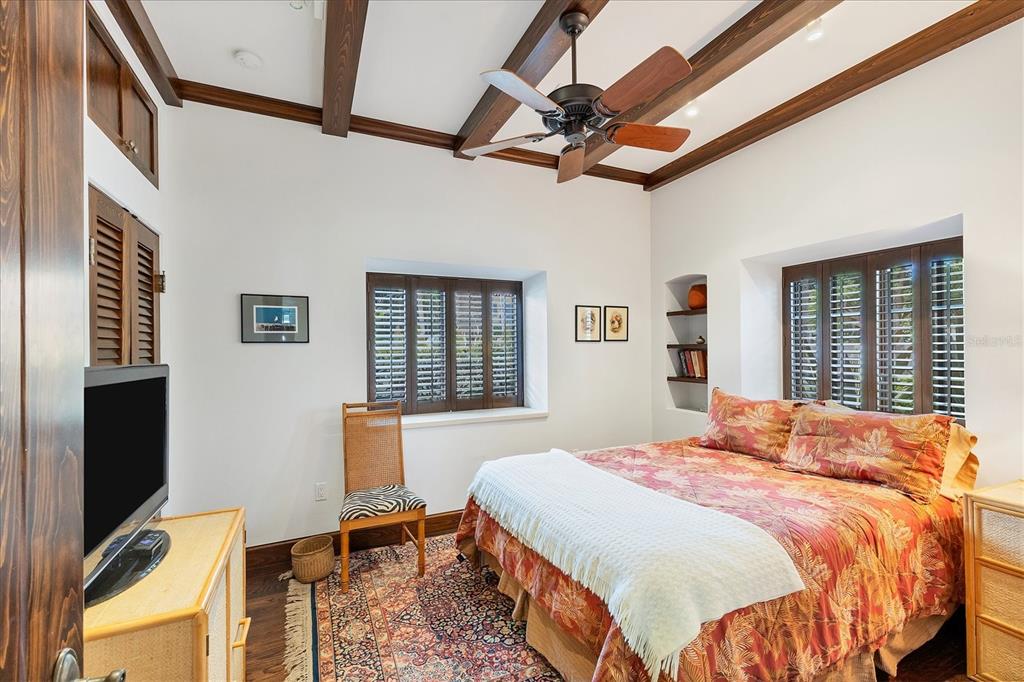 1021 10th Street West Boca Grande, FL 33921 - Photo 14 of 34 a bedroom with a bed and a flat screen tv