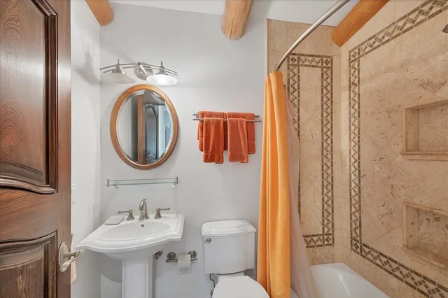 a bedroom with two beds and windows