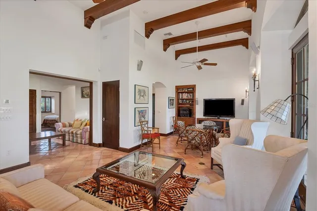 a living room with furniture a rug and a flat screen tv