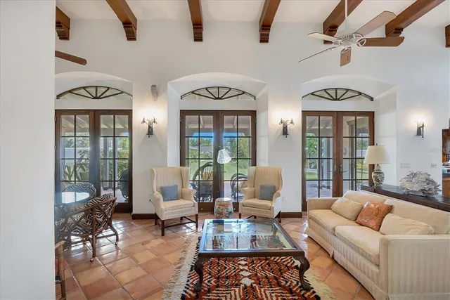 a living room with furniture fireplace and a large window