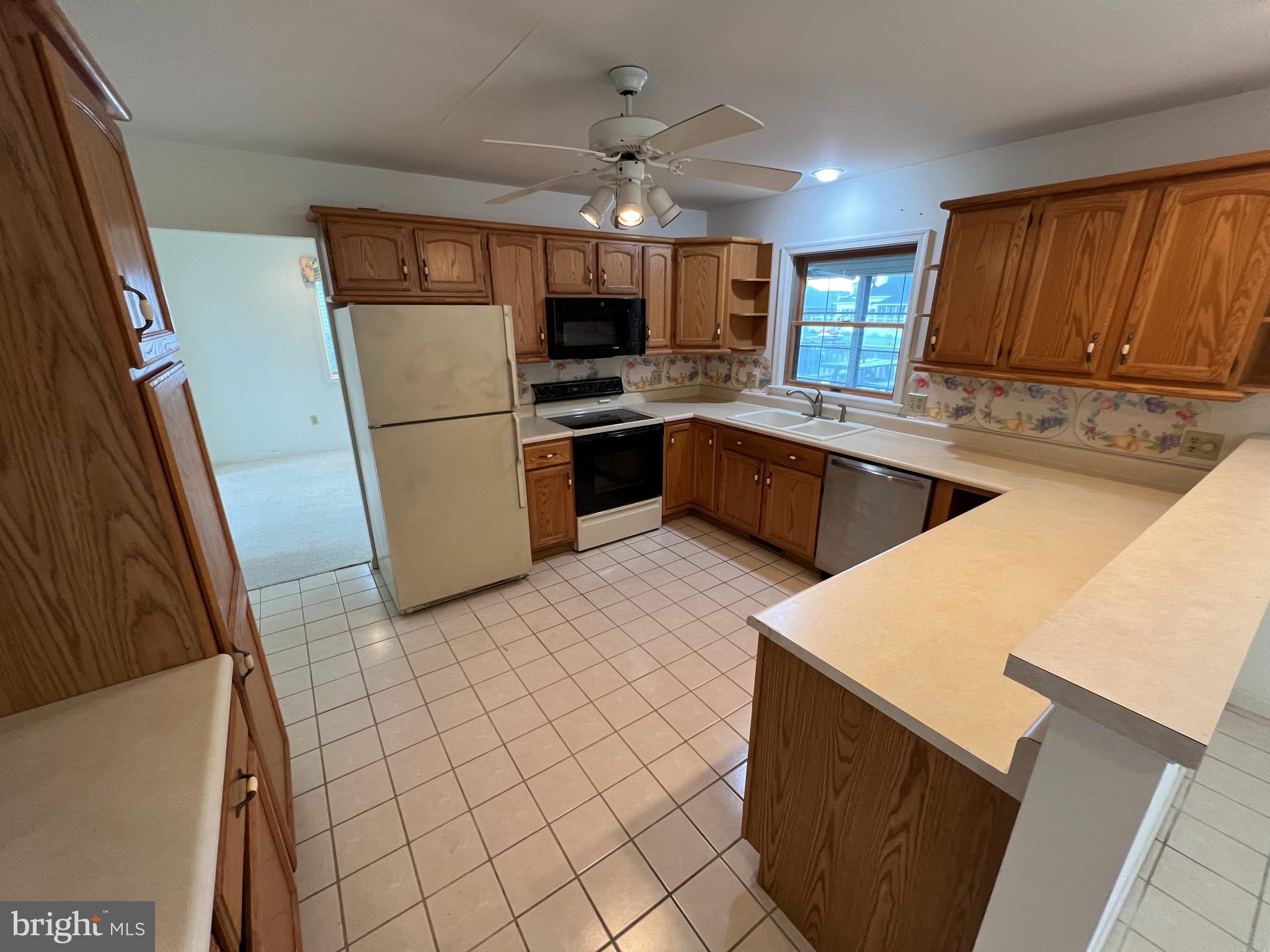 6 Ebb Tide Berlin, MD 21811 - Photo 26 of 53 a kitchen with stainless steel appliances a refrigerator a sink a stove top oven and cabinets