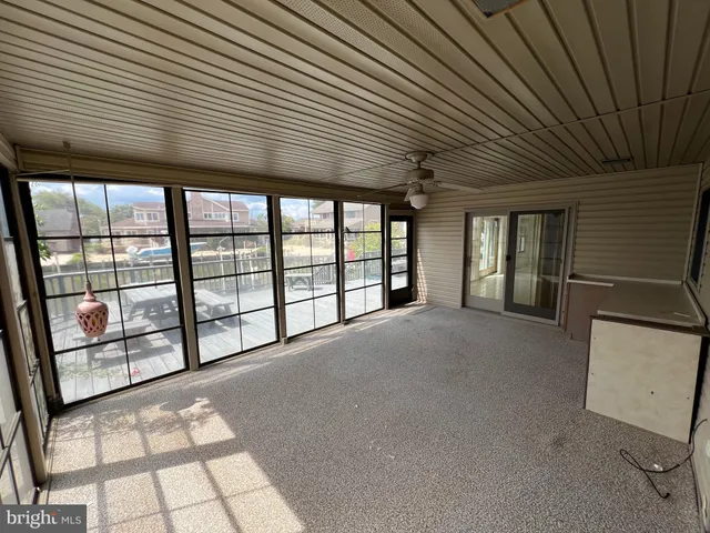 an empty room with windows and closet