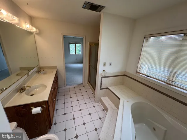 a view of a room with a ceiling fan and window