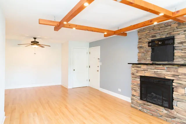 a view of a livingroom with a fireplace and a window