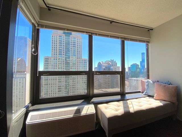 a bedroom with a bed and a large window