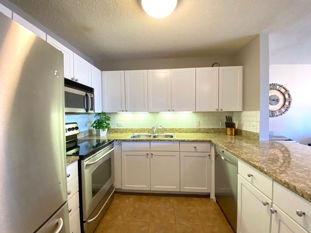 a kitchen with sink cabinets and window