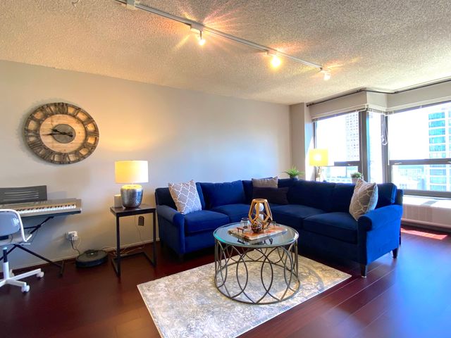 a living room with furniture a rug and a window