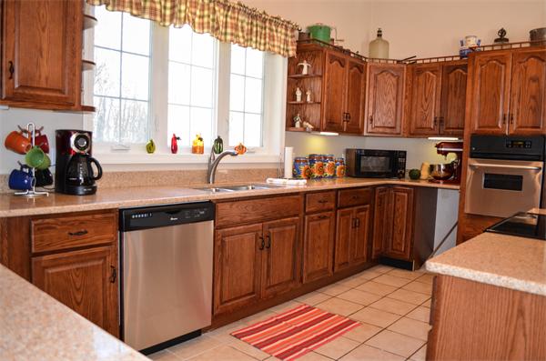58 Hartness Road Sutton, MA 01590 - Photo 7 of 27 a kitchen with stainless steel appliances a sink a counter space and a window
