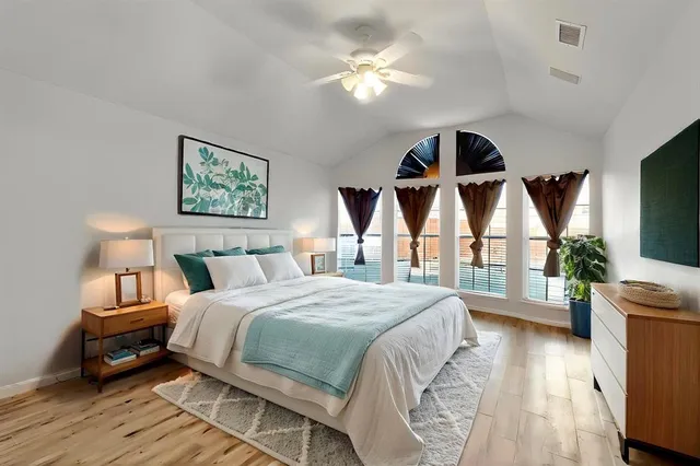 a bedroom with a large bed and a chandelier