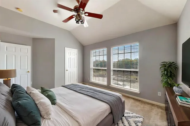 a bedroom with a large bed and a window