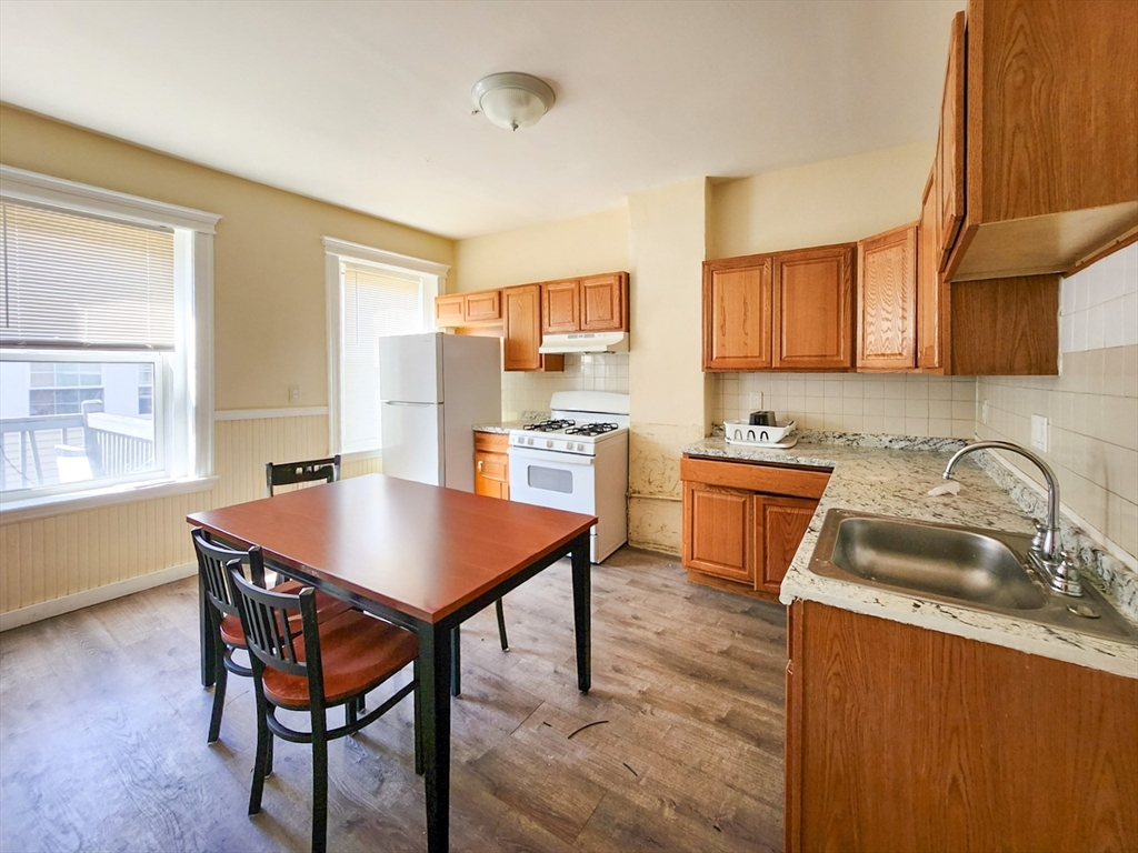35 Abbotsford Street, Unit 3 Boston, MA 02121 - Photo 2 of 6 a kitchen with a stove a sink a microwave and a refrigerator