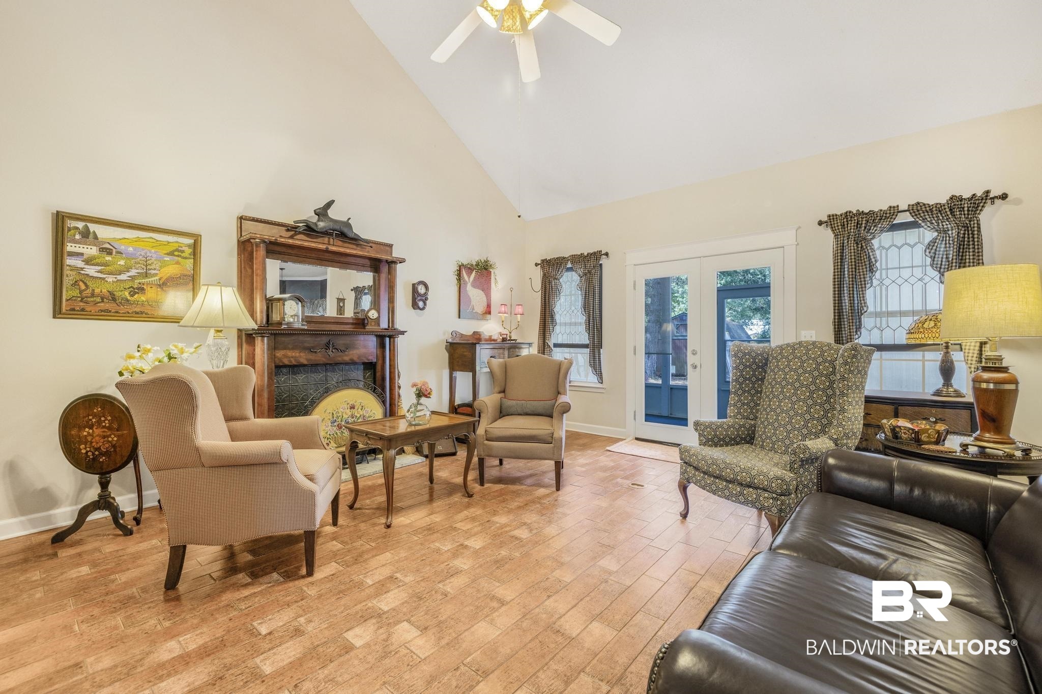 10603 Old Stage Road Stockton, AL 36579 - Photo 11 of 34 Living room with high vaulted ceiling, light wood-type flooring, french doors, and a fireplace