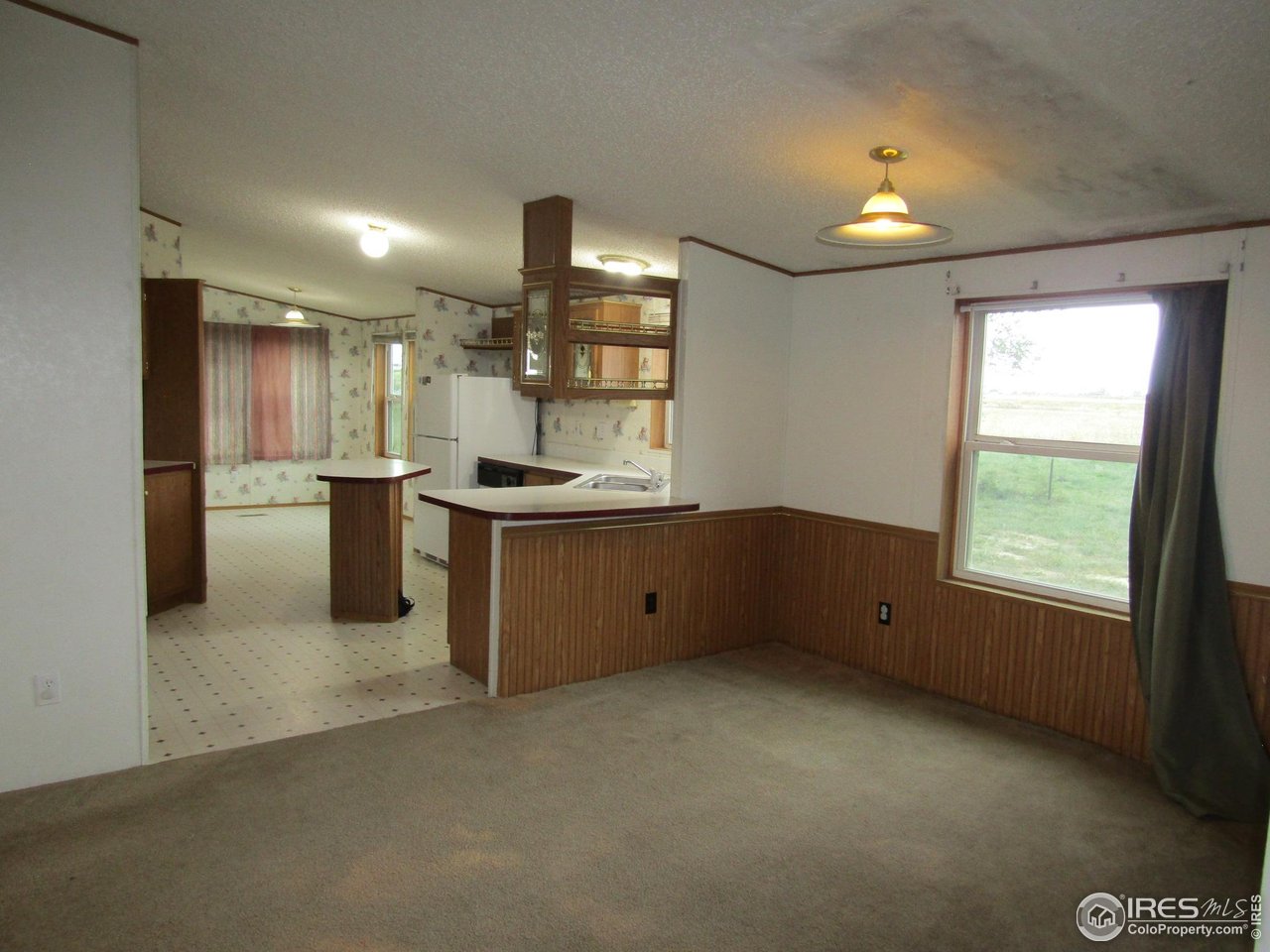 18500 Centennial Road Fort Morgan, CO 80701 - Photo 11 of 37 View of kitchen from dining room/breakfast bar between dining room & kitchen