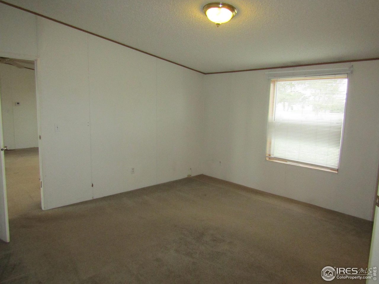 18500 Centennial Road Fort Morgan, CO 80701 - Photo 19 of 37 View of primary bedroom from walk in closet