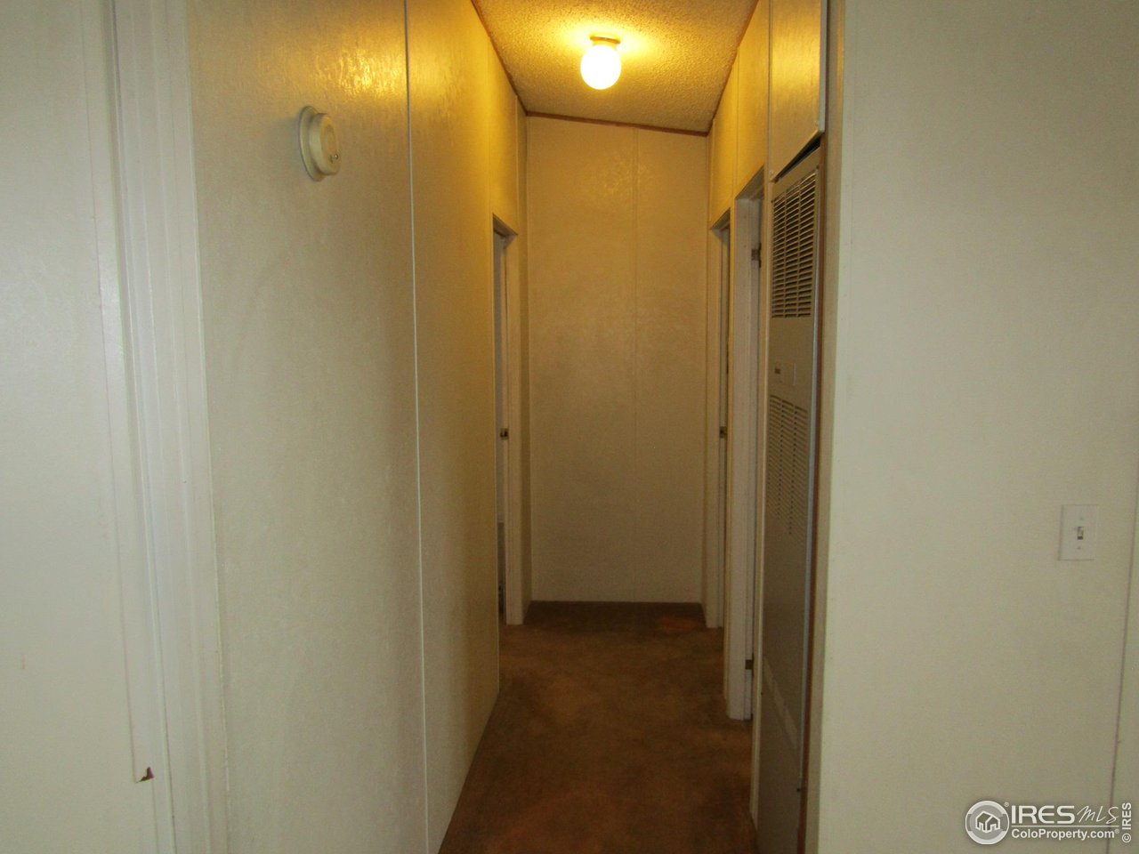 18500 Centennial Road Fort Morgan, CO 80701 - Photo 24 of 37 Hallway to main bathroom/furnace/ 2 bedrooms