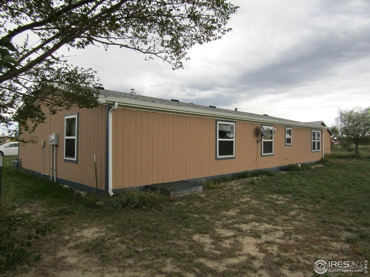 18500 Centennial Road Fort Morgan, CO 80701 - Photo 28 of 37 West side and back of house/crawl space access entrance