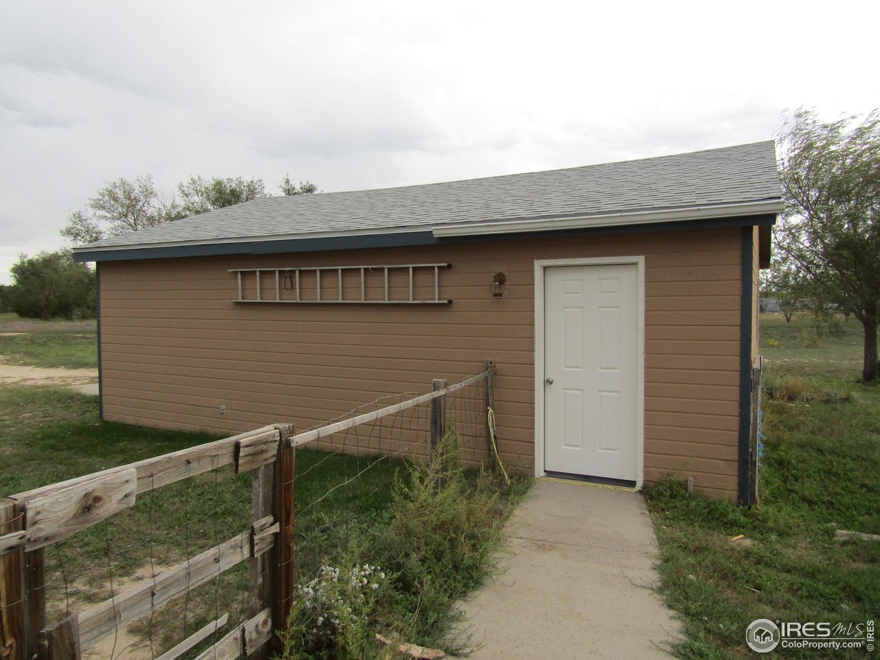18500 Centennial Road Fort Morgan, CO 80701 - Photo 33 of 37 View of garage with new walk in door from east side door of house